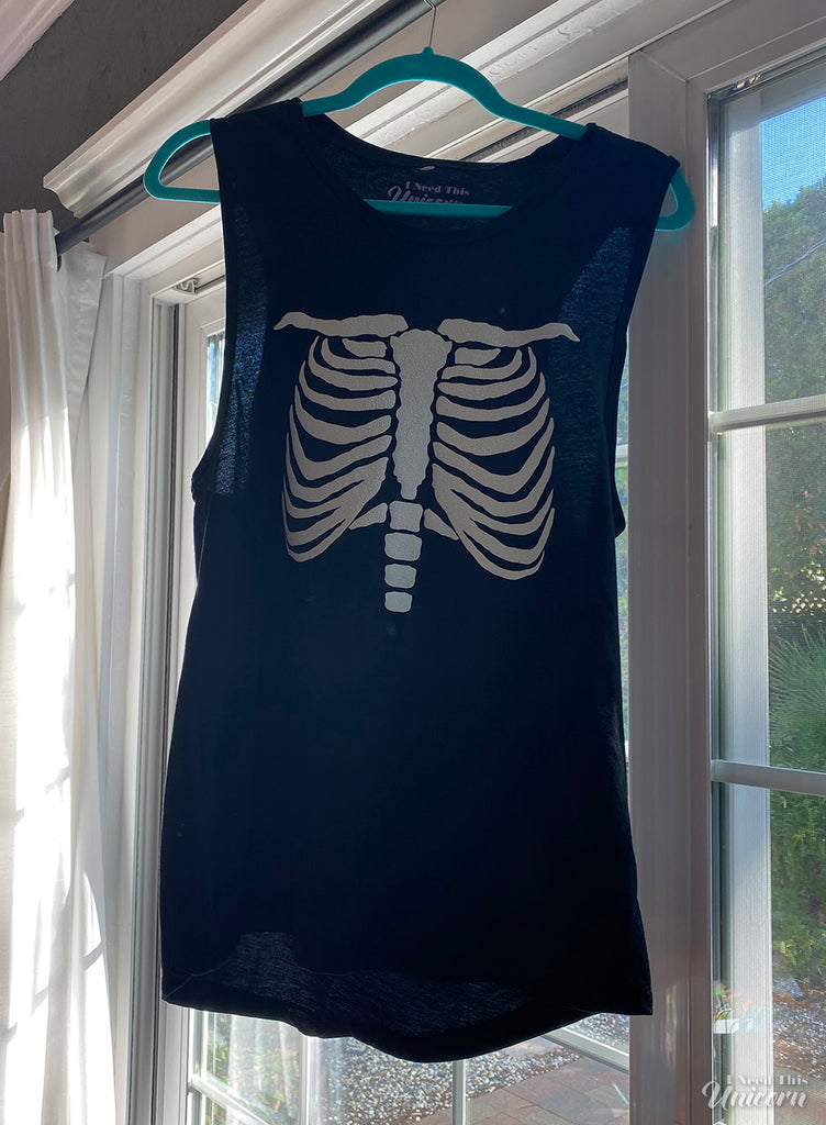glow in the dark skeleton ribcage vinyl on a black muscle tank top for women