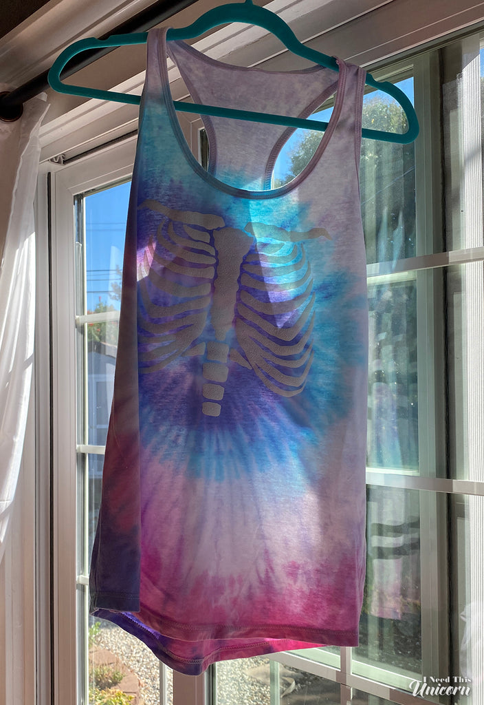 glow in the dark puff on a unicorn cotton candy colored tie dye racerback tank top for women