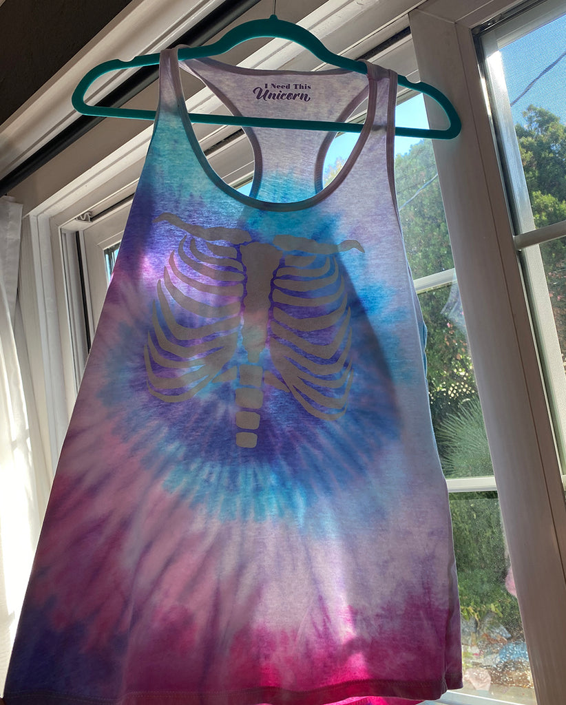 glow in the dark puff on a unicorn cotton candy colored tie dye racerback tank top for women